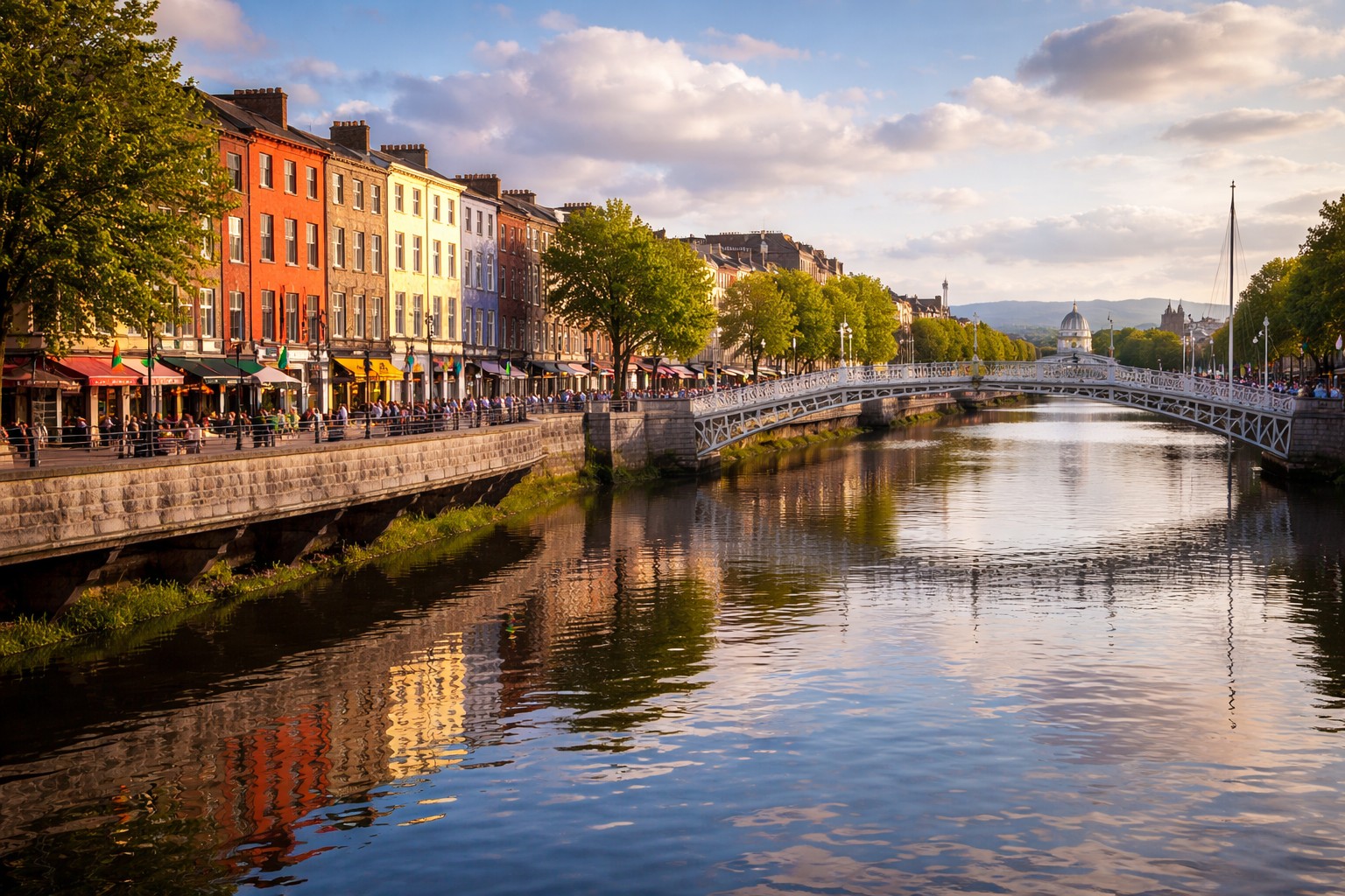 Dublin city centre along the River Liffey with Ha’penny Bridge and colourful riverside buildings.